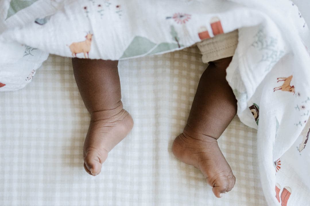 Parent helping a child into a soft POORR lounge set.